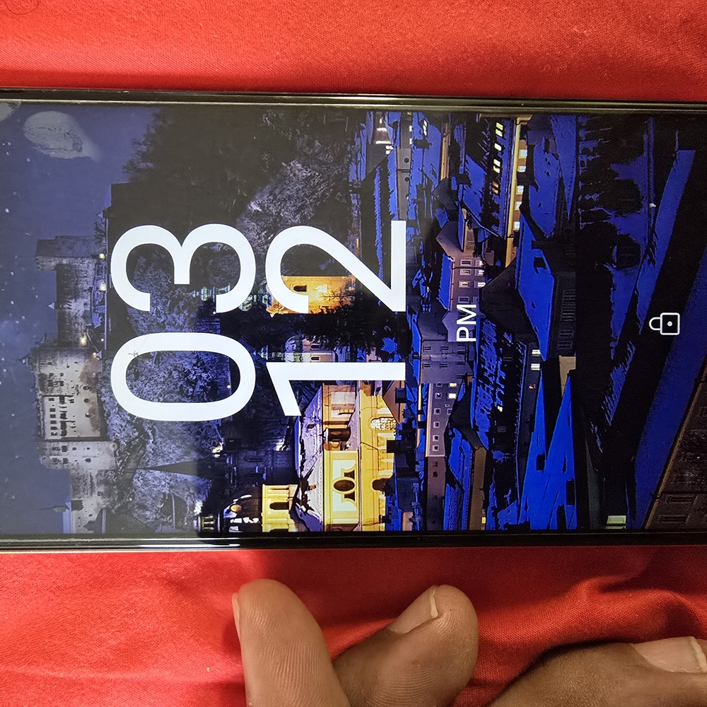 Black Smartphone with Scenic Wallpaper